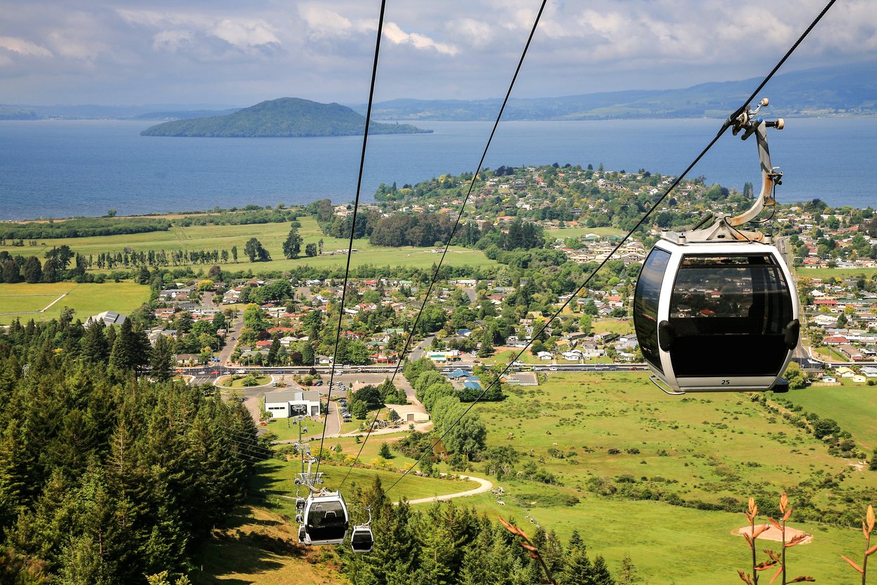 rotorua,new zealand Image of cable car with lake and mountains of  Rotorua, New Zealand in the background